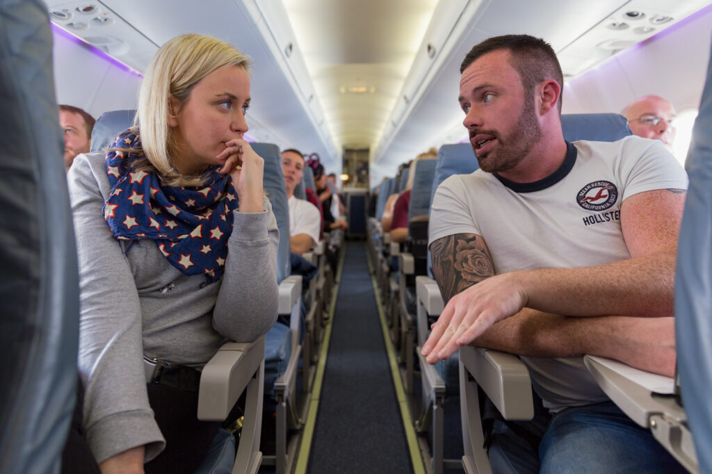 Unit stills photography on location in Amsterdam. People have a conversation over a plane aisle